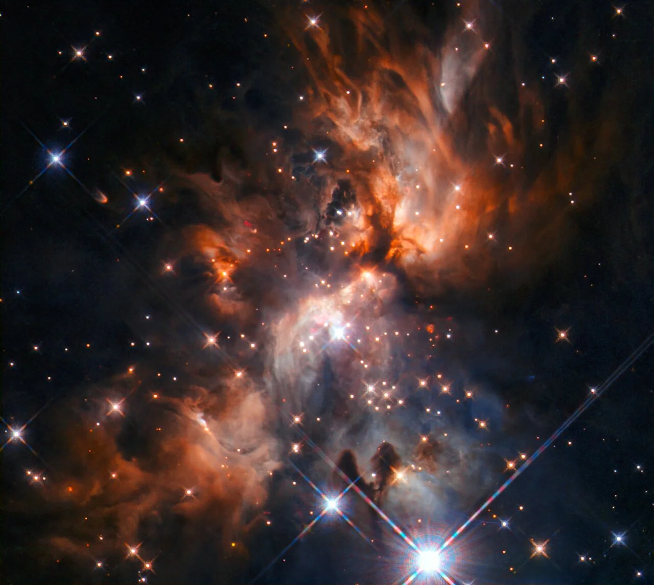 Newborn Massive Star Carves Light‑Escaping Cavities in Nebula